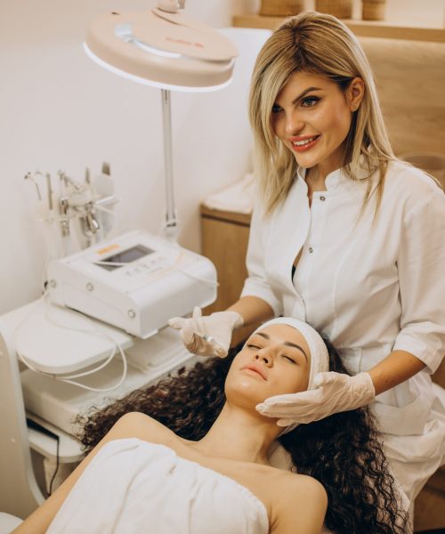 Woman making injections at cosmetologist